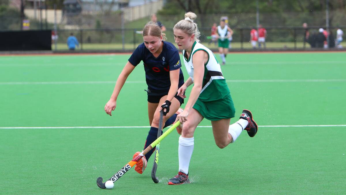 Close contest: University's Lucinda Preeo (left) and Albion Park's Montana Marsh compete during Saturday's grand final. Picture: Sylvia Liber.