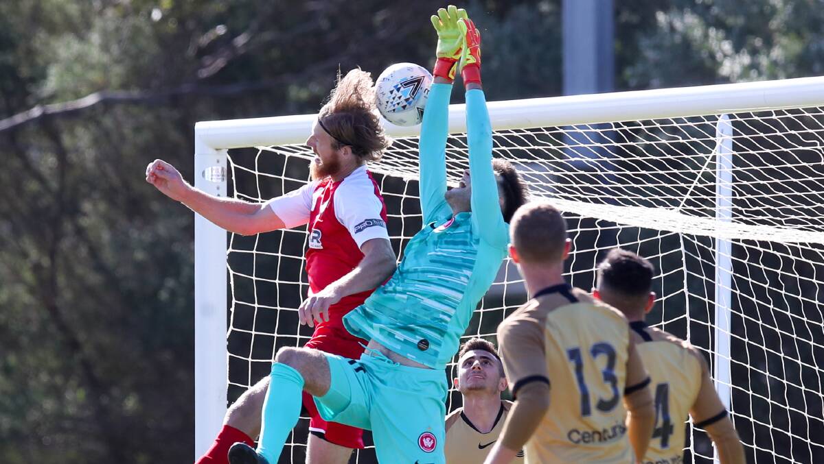 Aerial contest: Josh Bingham heads the ball past the Wanderers goalkeeper on Sunday. Picture: Adam McLean.