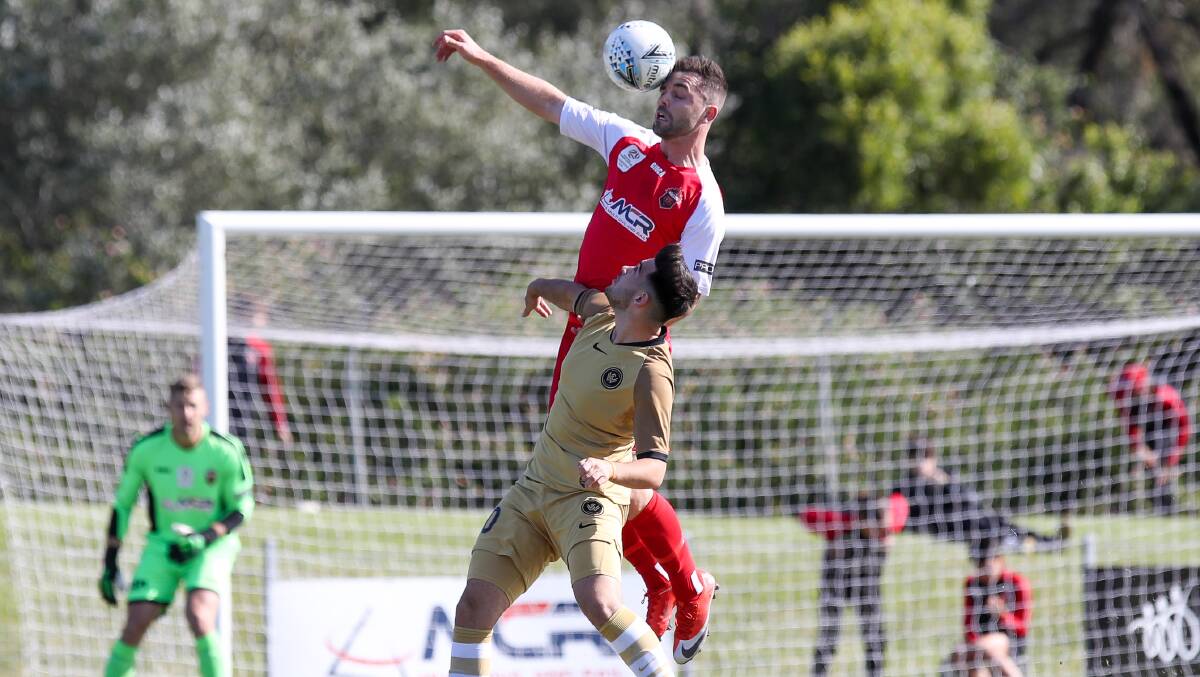 Climbing above their rivals: Wollongong's Taylor McDonald out leaps a Wanderers opponent last Sunday. Picture: Adam McLean.