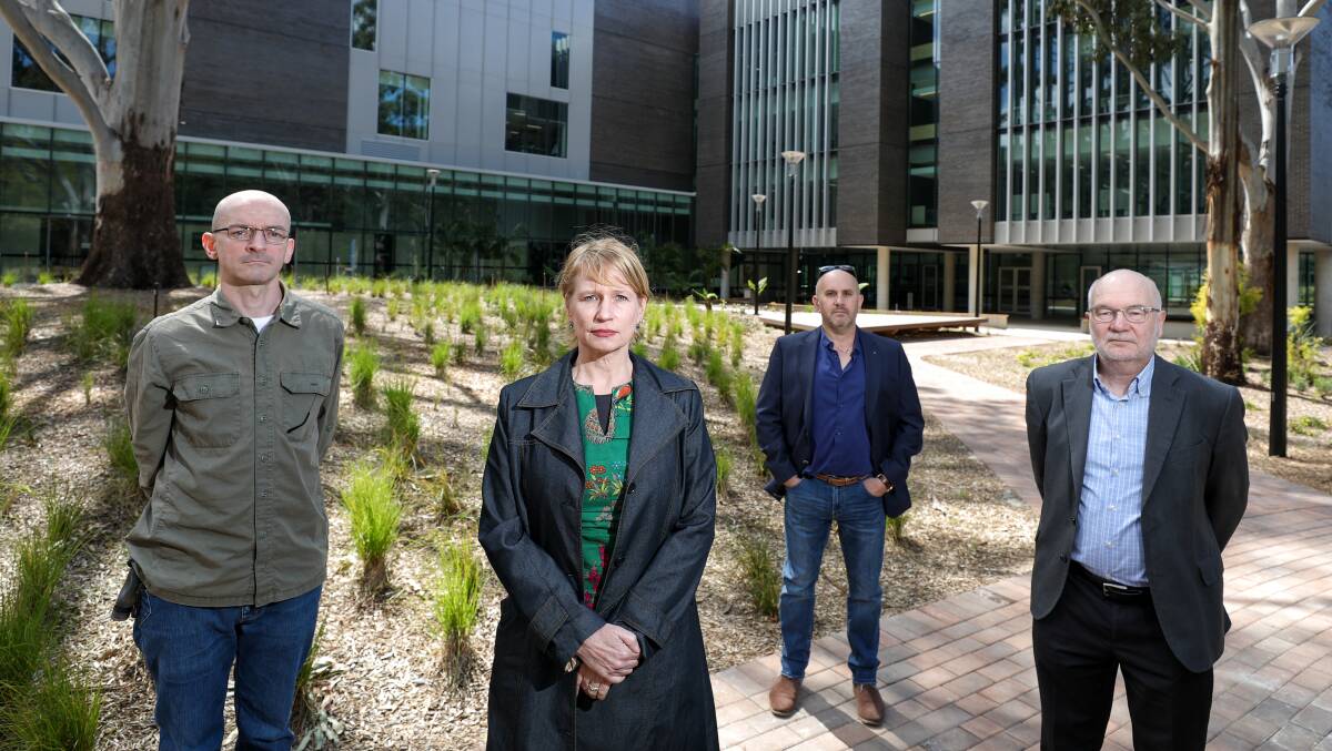 NOT HAPPY: University of Wollongong academics Andrew Whelan, Fiona Probyn-Rapsey, Marcelo Svirsky and Rod Vickers in front of the new social sciences building at the Wollongong campus. Picture: Adam McLean.