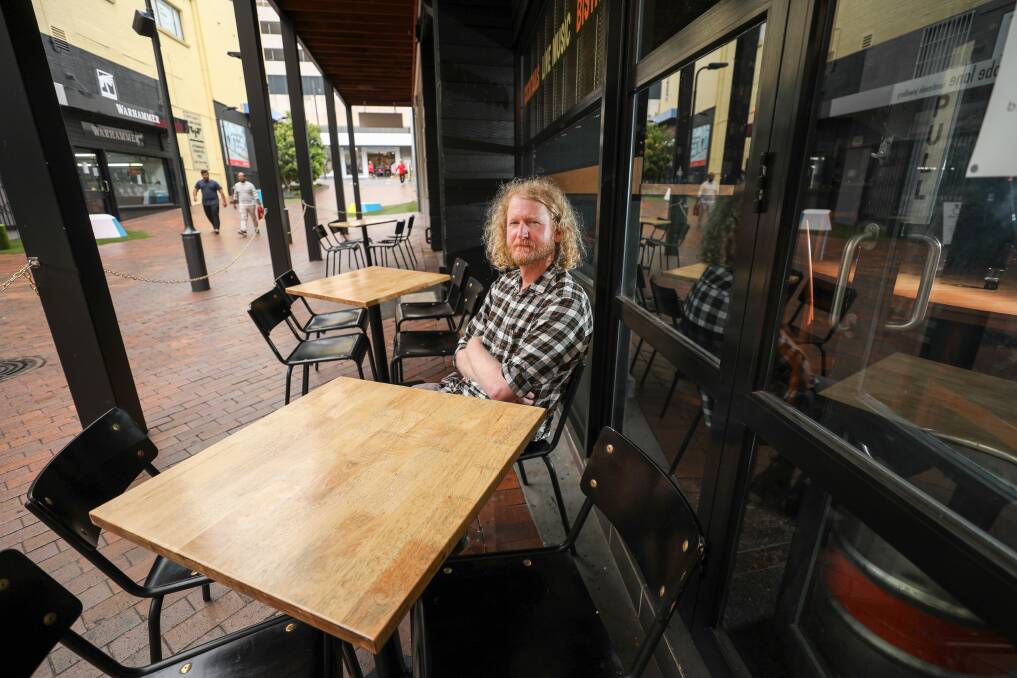 ANNOYED: 'Nothing worse than sitting at a wonky table,' says Nathan Stratton, who pays $3,500 for sloping alfresco space outside La La Las. Picture: Adam McLean.