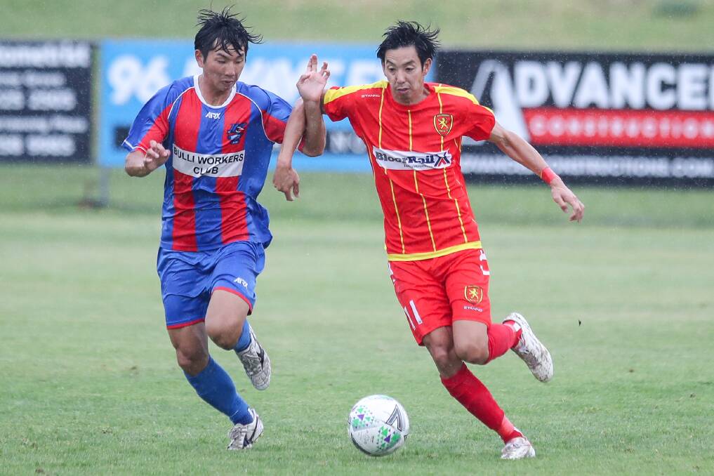 Evenly matched: Woonona's Tomohiro Ishii (left) and Wollongong United's Kawasakiya Hikaru fight for possession during the IPL major semi-final. Picture: Adam McLean.