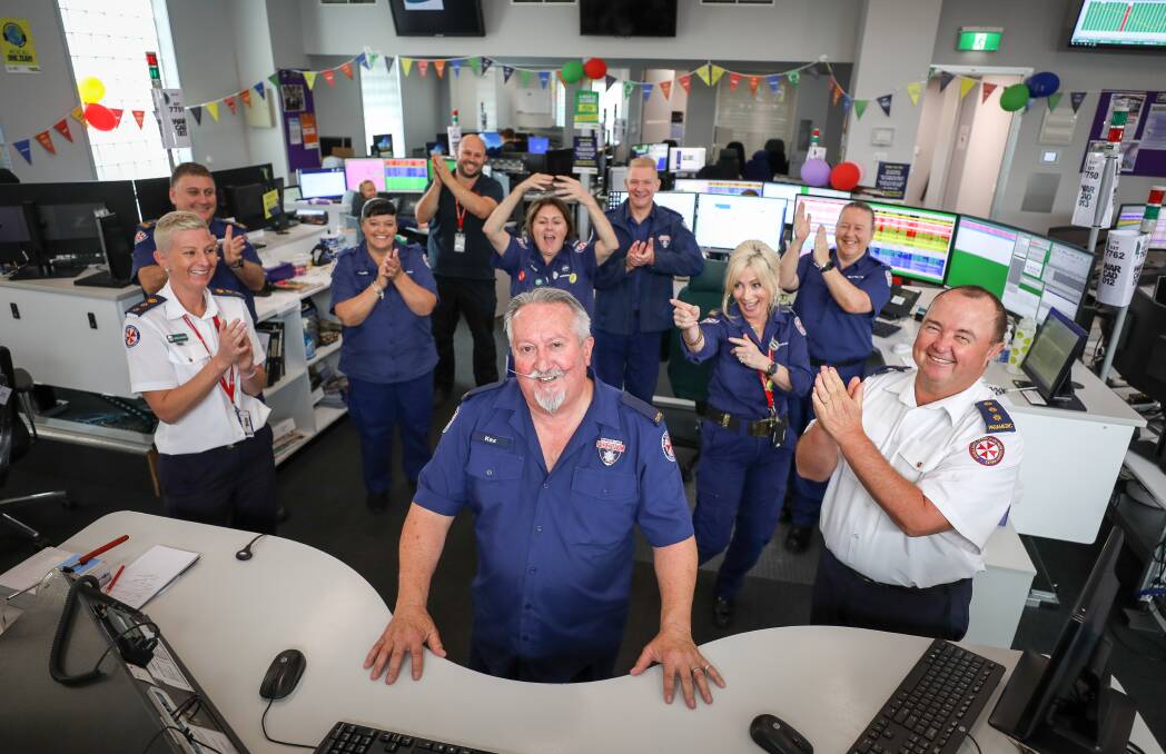 HIP HOORAY: NSW Ambulance colleagues cheer Kerry Thompson on his retirement after 35 years, at the Southern Control Centre in Barrack Heights on Tuesday. Picture: Adam McLean.