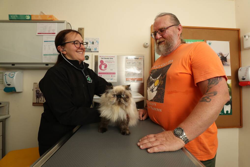Dr Lucy Asher with Astrid and her owner Russell Walton at Greencross Vets West Wollongong. Picture: Robert Peet