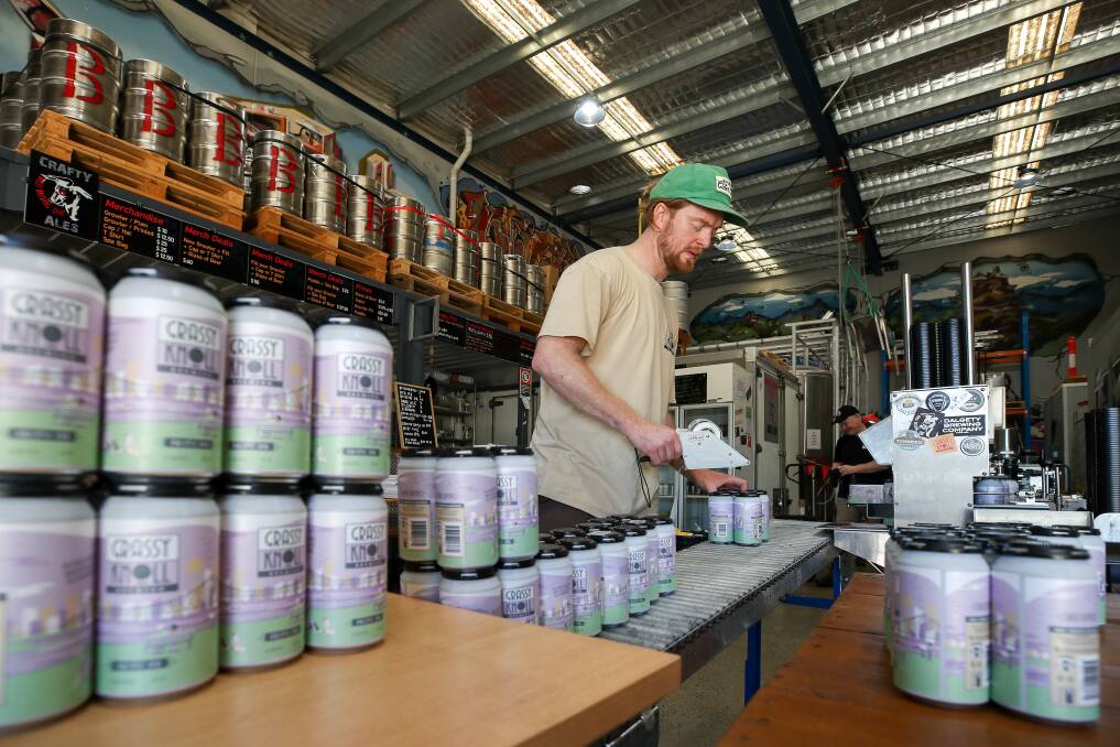 Sharing: Grassy Knoll's Jeff Argent canning his beers that are brewed in someone else's facility - Bulli Brewing in Unanderra. Despite notionally being business rivals, the arrangement is working for both parties. Picture: Adam McLean.