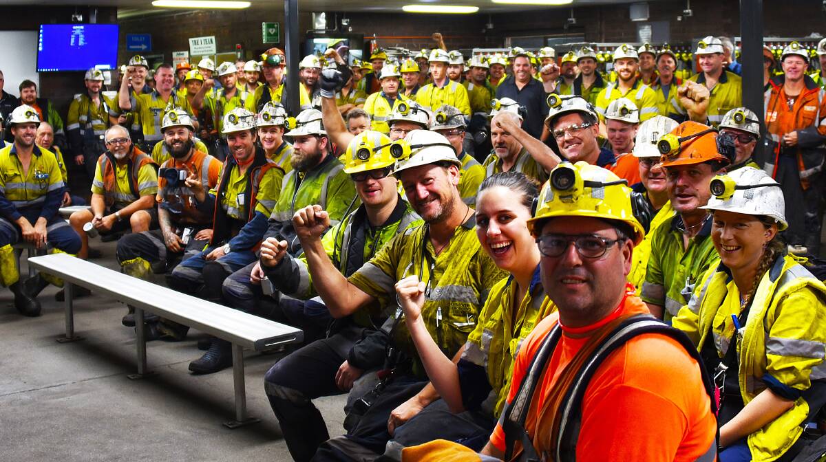 SECURITY: This picture supplied by the mine shows workers at one of the daily briefings showing their feelings at gaining certainty that their jobs would continue.