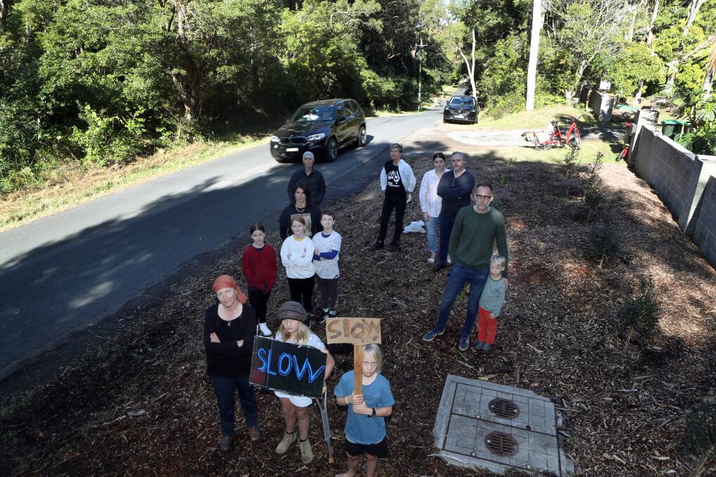 JUST SLOW DOWN: Kylie Madden (front left) with her children and nearby residents concerned the back roads are becoming too dangerous. Pictures: ROBERT PEET.
