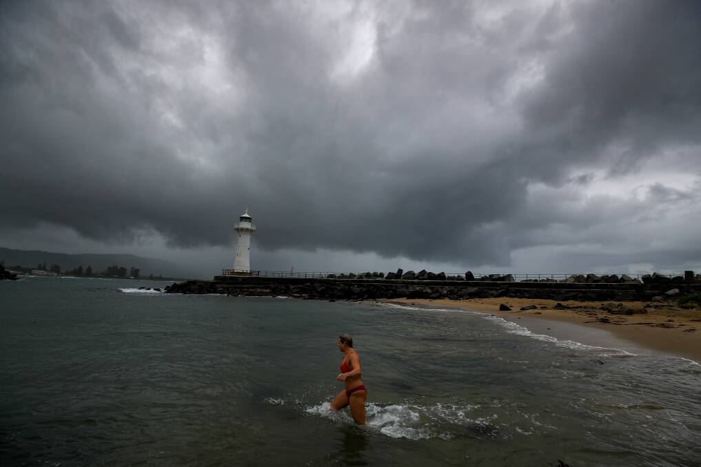WHY NOT: Wollongong resident Whitney Geoghegan wasn't put off by the stormy weather, heading in for a swim in the harbour on Thursday. Picture: ADAM McLEAN.