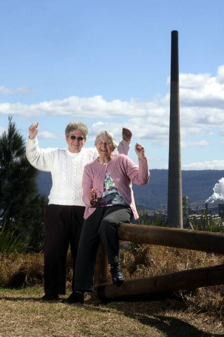 COMRADES: Olive and Helen Hamilton (left) celebrating the decision to demolish their old adversary, the copper smelter stack in 2010.