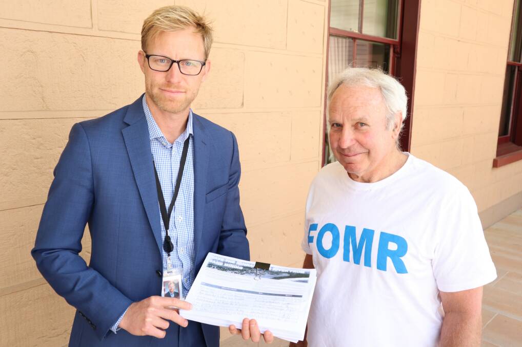 Line in the sand: MP Justin Field with Gerroa Environment Protection Society President Warren Holder and the petition on Wednesday.