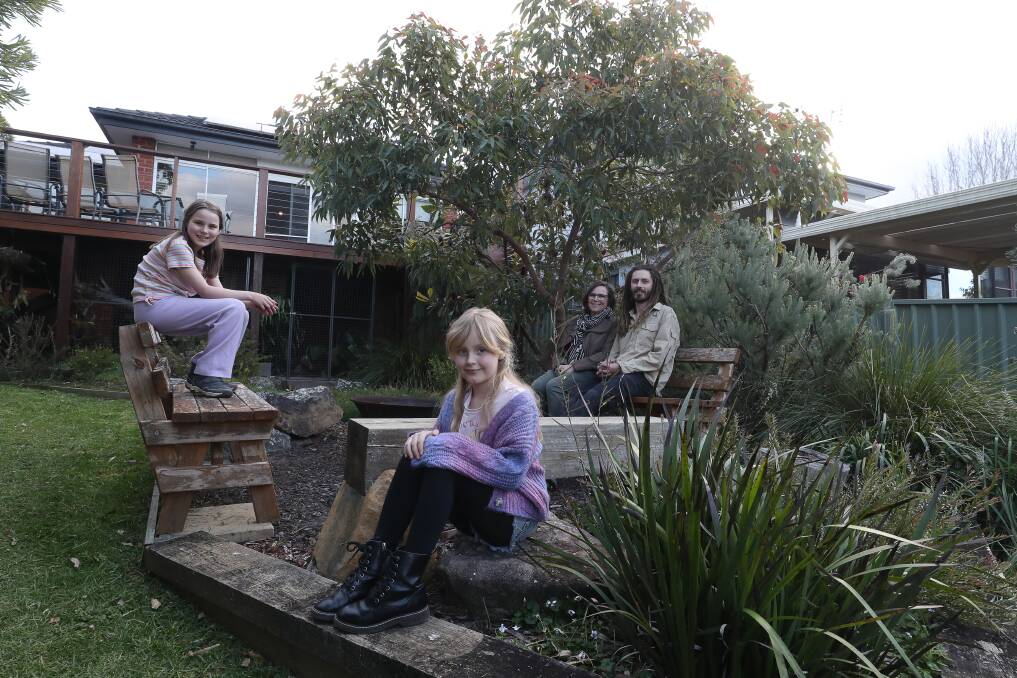 Arkie and Cora Purnell in the garden of their Mount Kembla home with parents Sheridan Novotny and Tye Purnell. Picture by Robert Peet