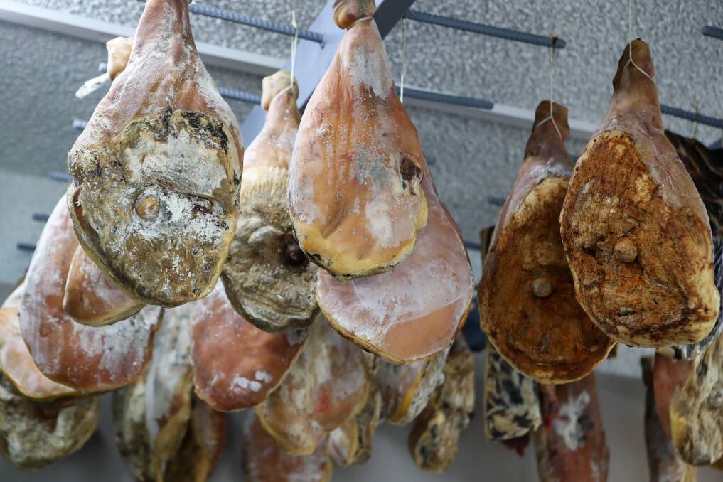 Prosciutto hangs form the ceiling at Paul's.