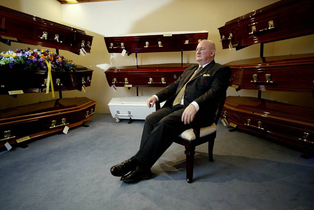 Warwick Hansen, pictured among caskets in 2004, said being a good listener is essential to helping people who are grieving.