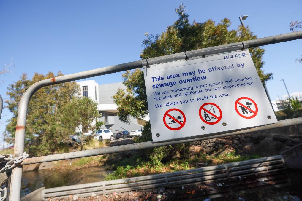 Picture this week shows a sign warning of sewage overflow near Wollongong Golf Course. Picture by Adam McLean