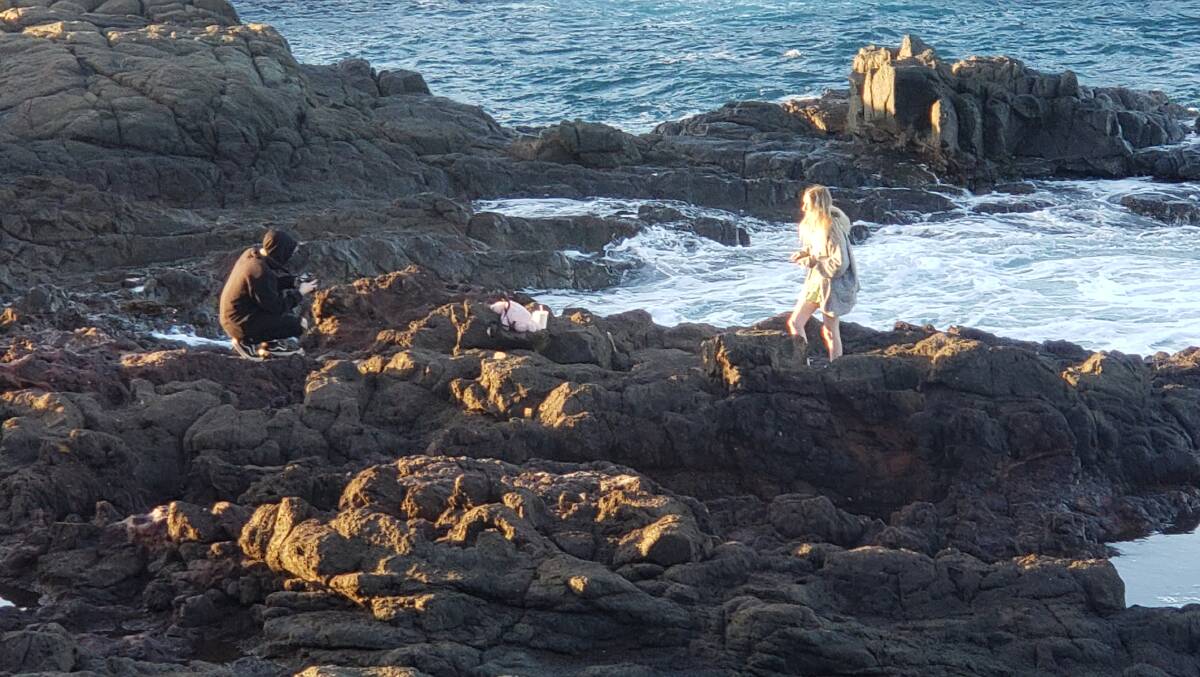 FILM IT: Onlookers cleaned up after these two who indulged their Tik Tok trends at Bushrangers Bay. Picture: Anthony Spicer-Leask.