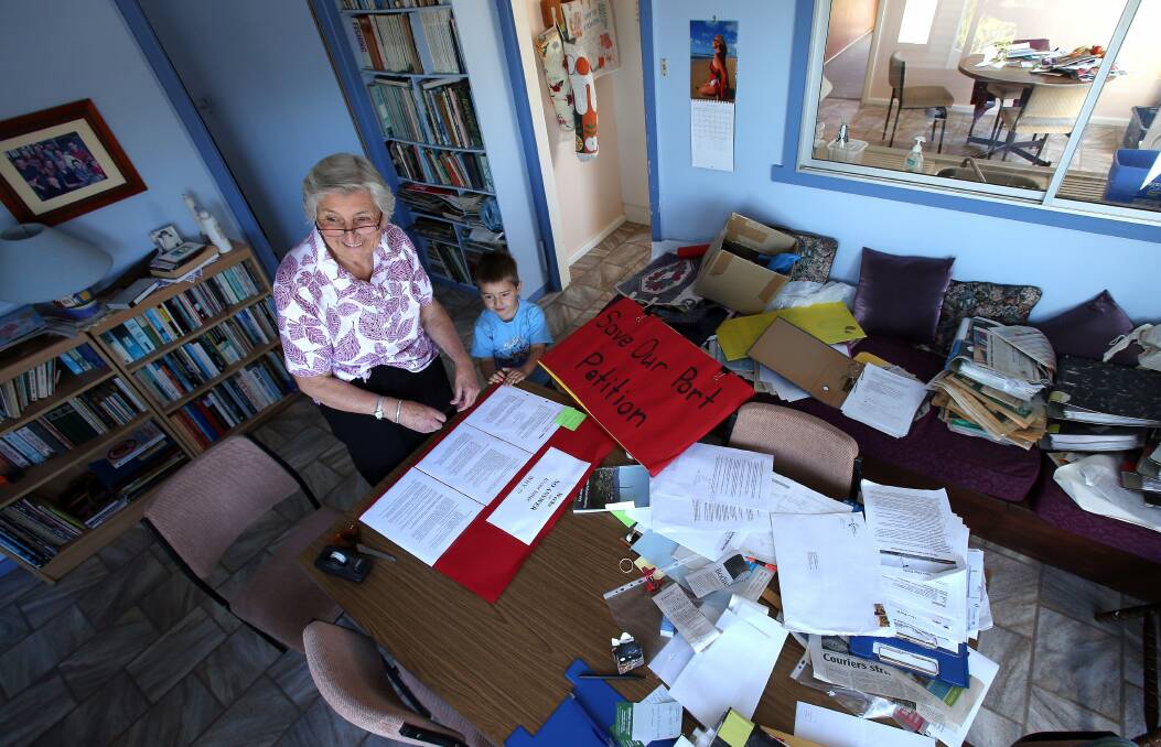 HOME FRONT: Olive Rodwell putting together a petition against the sale of Port Kembla in 2012, with grandson Caleb. Her files have filled a whole room. Picture: KIRK GILMOUR.