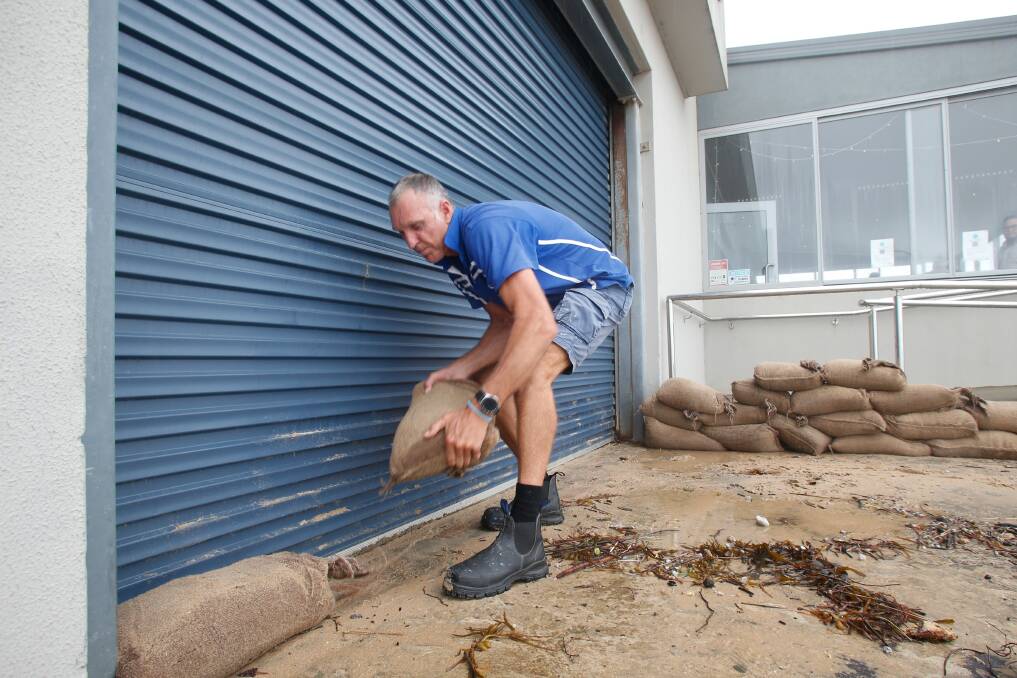 Thirroul Surf Club captain Ian Sakoff said 'the sandbags saved us' after sea water, sand and debris innundated Thirroul Esplanade but did not penetrate the club. Picture: Anna Warr