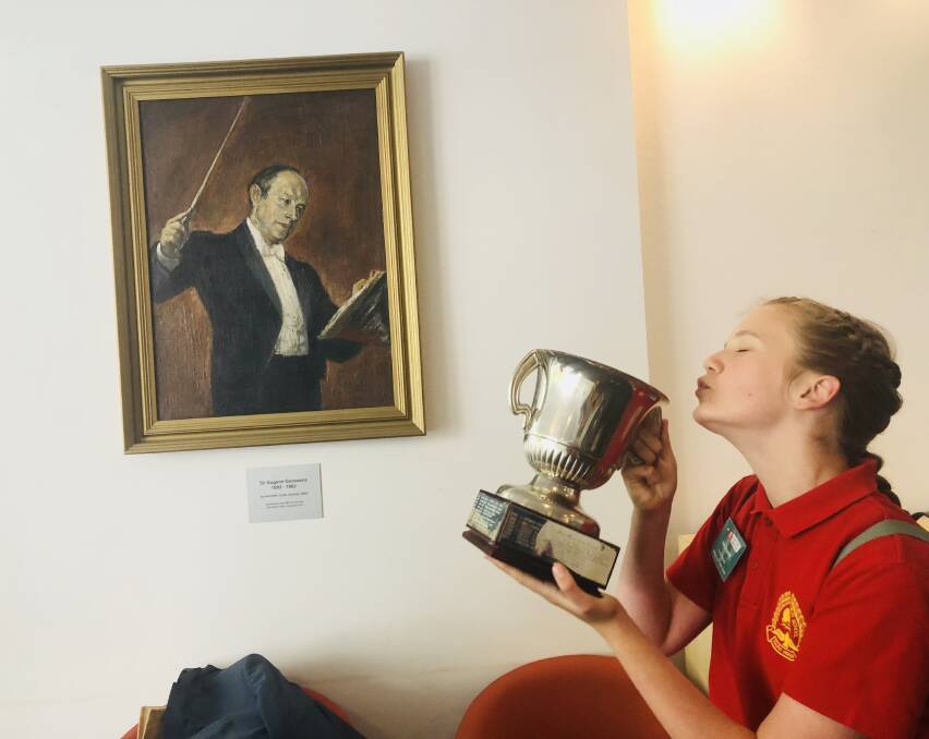 HOW SWEET IT IS: Scarborough student Ava Dupont with her trophy and a portrait of Sir Eugene Goossens at ABC headquarters in Sydney. Picture: Elizabeth Tadic.