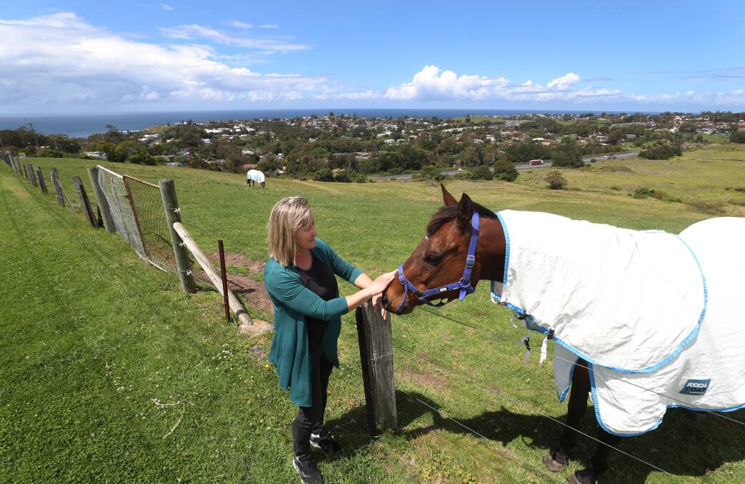 MAKING A STATEMENT: Kiama councillor Jodi Keast and friend on the boundary of the land proposed for rezoning under the plan now being reviewed.
