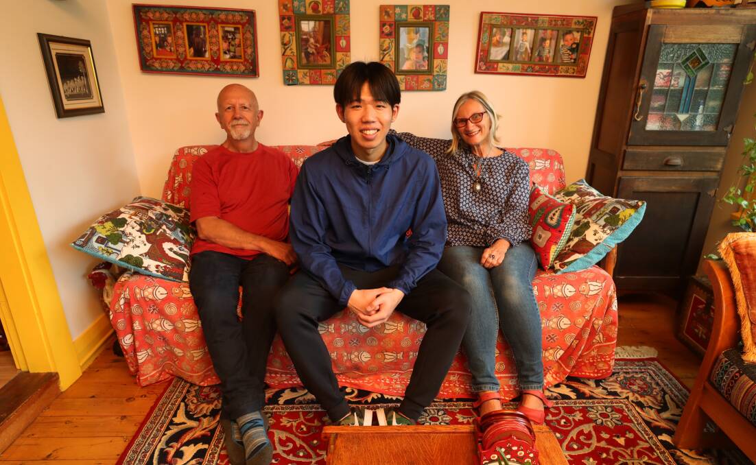 Keishi Sasaki, 20, from Nagasaki with Dave and Maureen Burt, of Keiraville, who said many students come back to visit with their families. Picture by Robert Peet.