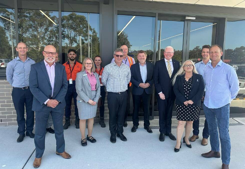 Member for Kiama Gareth Ward (fourth from right), Shellharbour Mayor Chris Homer (right), deputy mayor Kellie Marsh (third from right) and council CEO Mike Archer (centre) at the airport announcement which wasn't. Picture supplied.