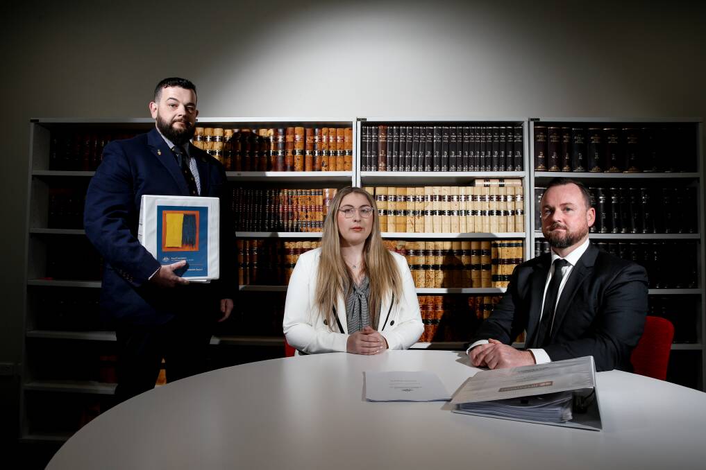 HEALING TIME: Paul James (holding the Royal Commission's interim report), Jacinta Harmer and Mick Bainbridge in Operational Legal Australia's Wollongong office. Picture: ANNA WARR.