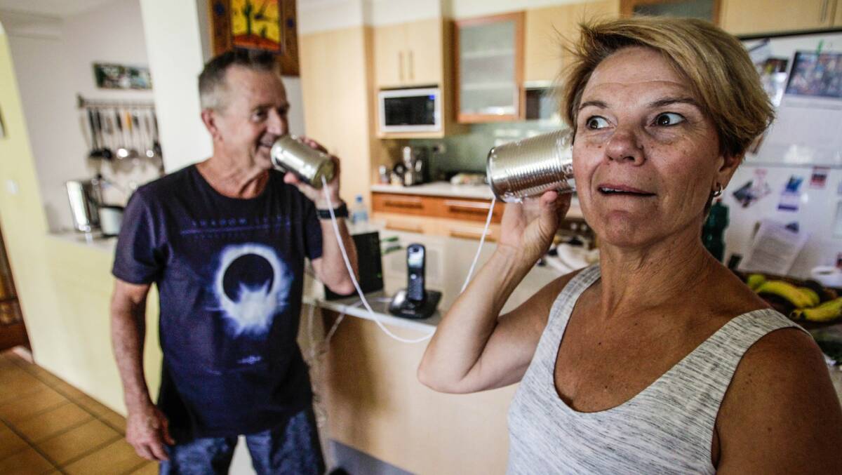Loud and clear, dear: Leeona Harrison can hear husband Rob better on the tin-can phone, than on their dead landline. Picture: Georgia Matts