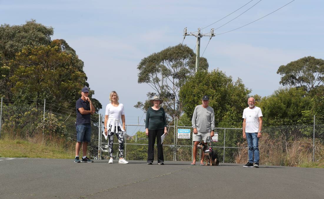 Tony Horneman, Charmaine Horneman, Annette Jones, Russell Dobbs with Rebel, and Ray Smith at the corner of Geraghty Street and Wilkies Street, which they say needs to be opened to traffic. Picture by Robert Peet.