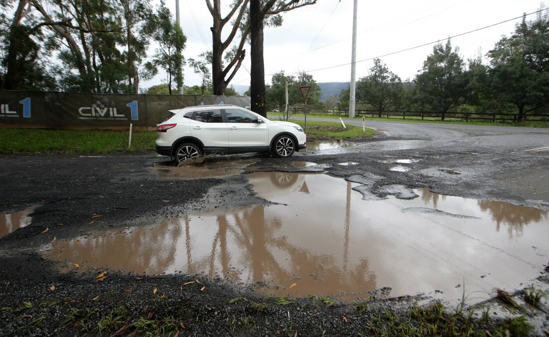 HAZARDOUS: The giant pothole on Darkes Rd at the corner of West Dapto Rd - almost big enough to swallow a car. See video on the Mercury website. Picture: Sylvia Liber.