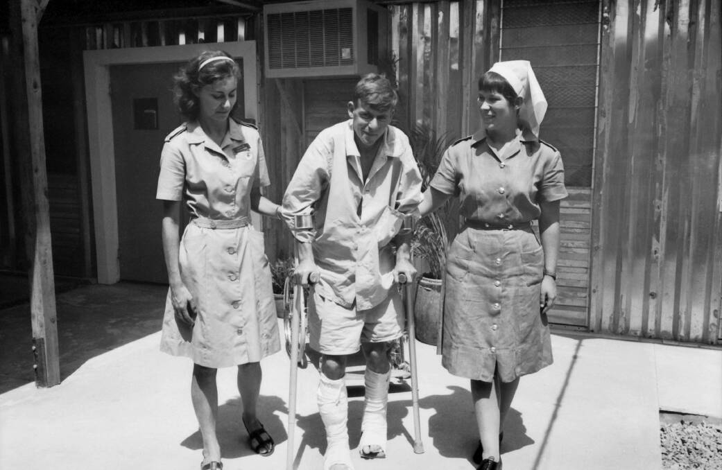 At Vung Tau, nursing sister Barbara Black assists Pte Merv Judd to take his first steps after being shot nine days earlier while on patrol. Picture courtesy AWM 