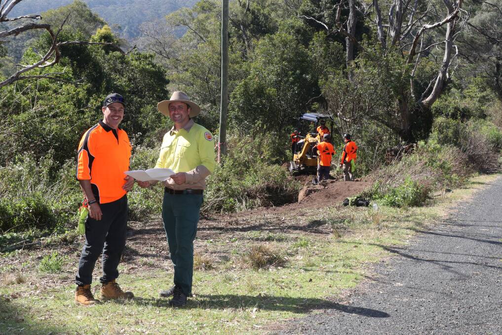 Synergy Trails director Adrian Main and Tom Pinzone from NSW NPWS at Mount Kembla as workers start on the first official track on the mountain. Picture by Robert Peet.