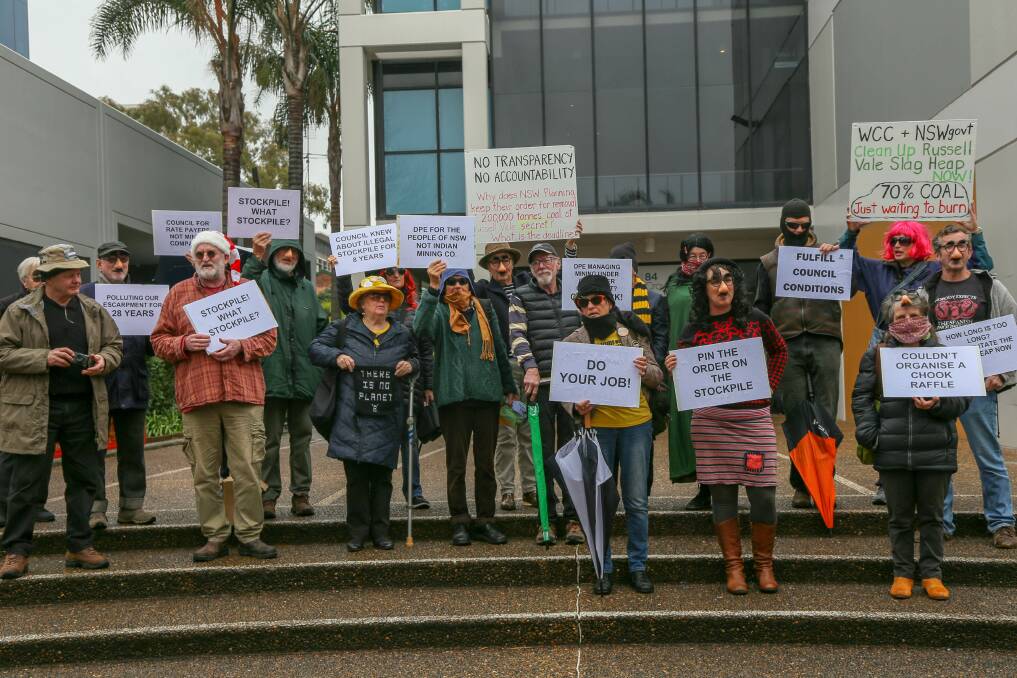 HIDDEN DETAILS: Environmentalists - including Councillor Mithra Cox - wore 'secret' disguises to protest the lack of information about Wollongong Coal's stockpile.