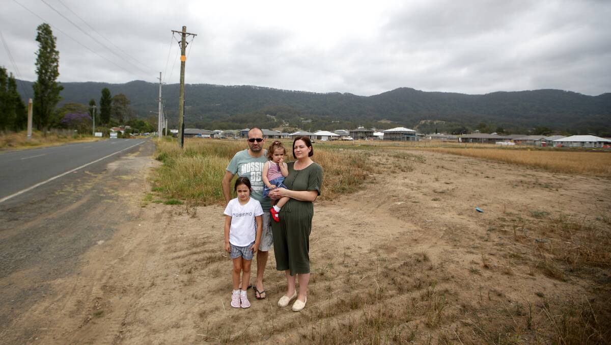 Ben and Natasha Panetta with children Sadie and Arianna at the site of the approved McDonalds at the intersection of West Dapto Rd and Raven St, Wongawilli. 