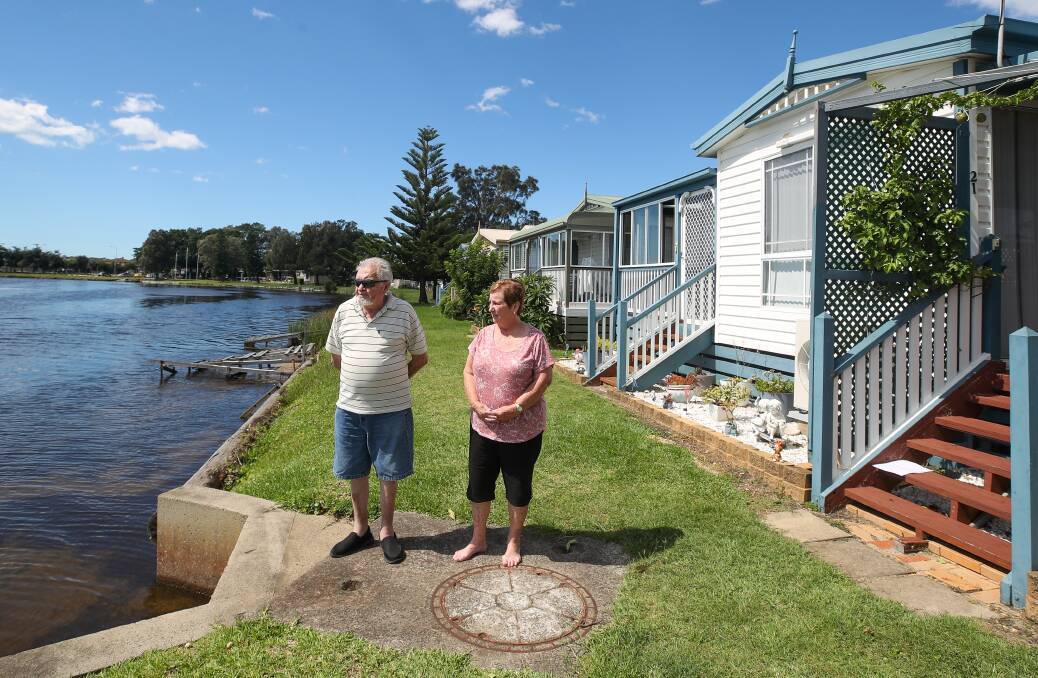 HARD TO HANDLE: At Jettys by the Lake in Windang, Kevin Croker and Lee Johnson are among the residents worried about being forced to raise their homes to 3m above sea level. Picture: Adam McLean