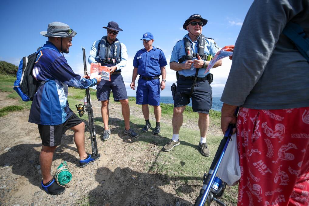 BE SMART: Officers from Transport for NSW, Marine Rescue and Port Kembla Water Police speaking with fisherman Ben Fidow on Friday. Picture: ADAM McLEAN.