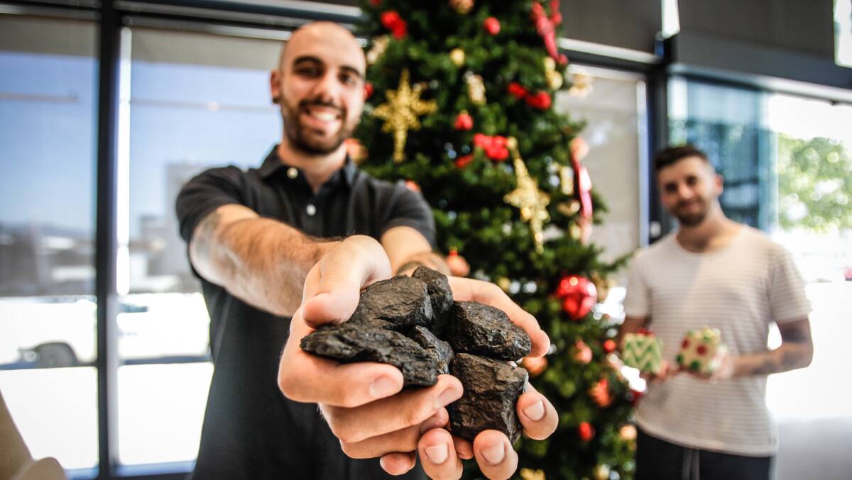 O Coal All Ye Faithful: Wollongong entrepreneur Luke Szalla is all generosity with a handful of coal this Christmas. Picture: Georgia Matts