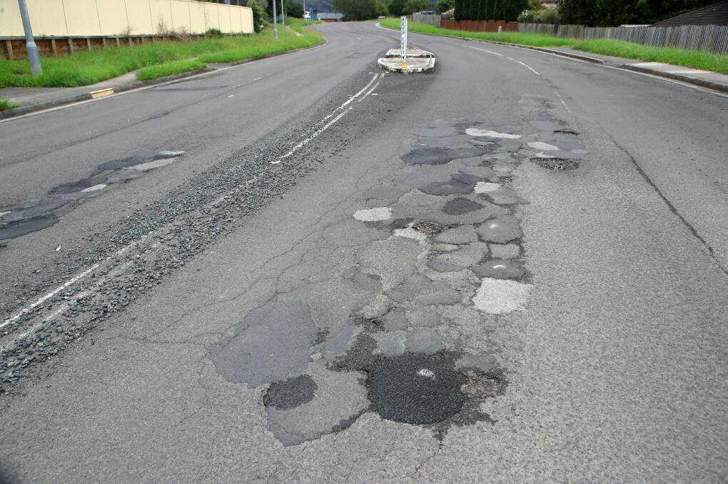 HOLEY MOLEY: The scene at Fairwater Dr, Horsley, which has been an ongoing problem for potholes, residents say. Picture: SYLVIA LIBER.