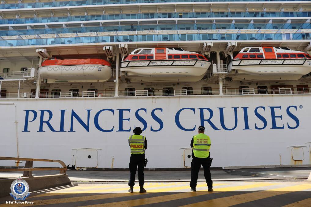 NOT CRUISING: Police, wearing facemasks for protection, stand guard the Ruby Princess.
