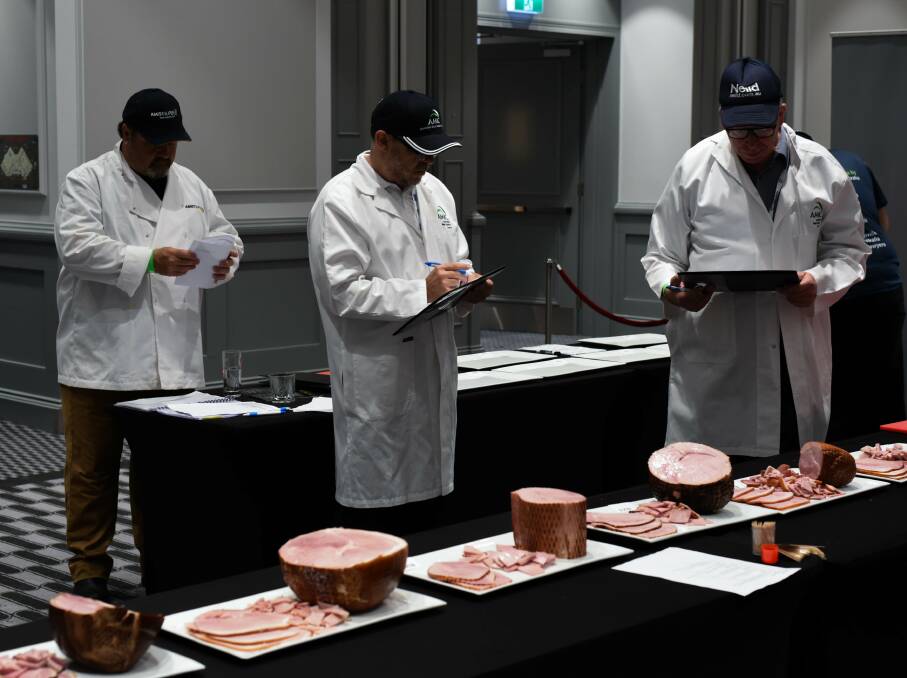 HAM-DLE WITH CARE: Judging was a serious business as these experts from the Australian Meat Industry Council get down to business on the hams.