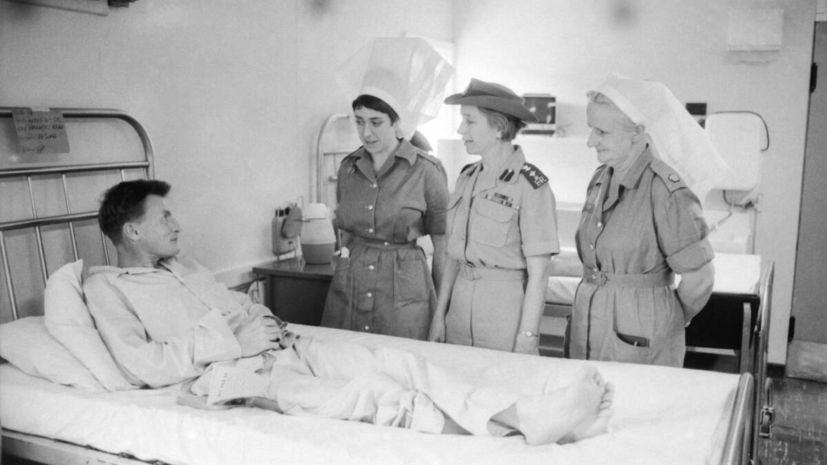 Sgt Len Dyer visited by the Matron in Chief of the Royal Australian Army Nursing Corps, Col Edna Doig (centre), nursing sister Capt Pam West and matron, Maj Nell Espie. Picture courtesy AWM
