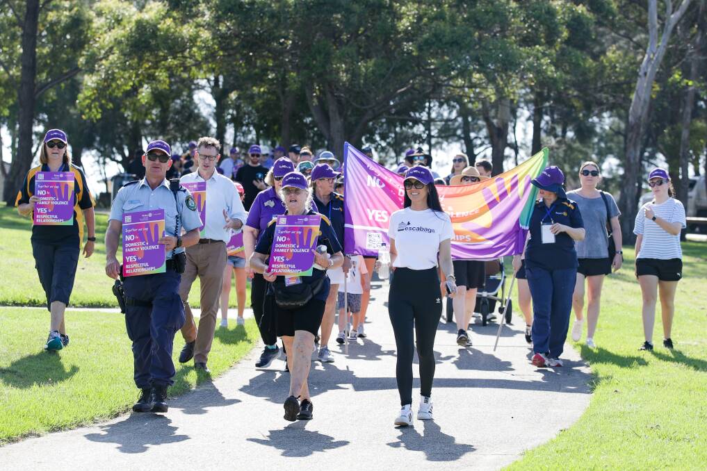 Lake Illawarra domestic violence officer Senior Constable Jeremy Harrison, Deb McIlwain from the Rotary Club of Dapto, and Escabags founder Stacy Jane lead the Say No! to Domestic Violence walk. Picture by Adam McLean.