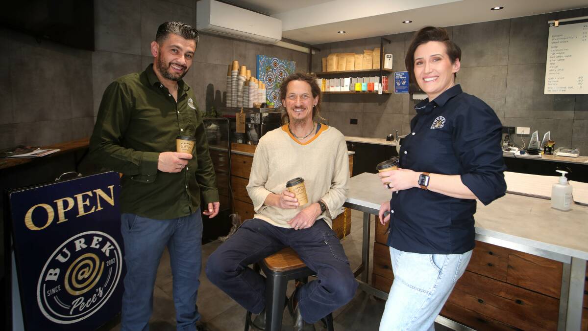 Community Cleaneruppa and a Cuppa organiser Brendan Reilly, centre, with Pece and Anita Miserlioski, from Cringila cafe Burek @ Pece's. Picture: Sylvia Liber