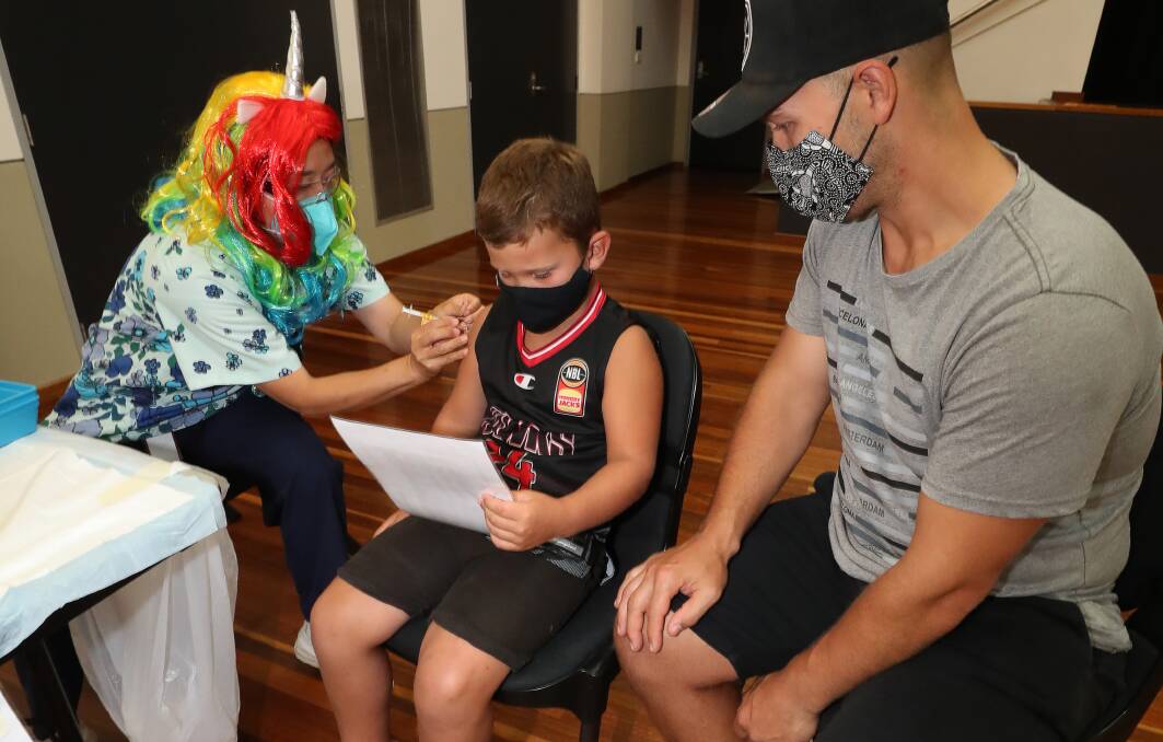 Hudson Sulter, 6, got his vaccination from Mitsy Sameshima with his dad Andrew by his side. Picture: Robert Peet