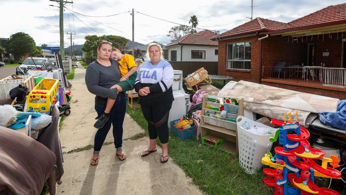 Claire Dewhirst, Liam Dewhirst, 8, and Jodie Pearce amid their ruined belongings outside the Achilles Avenue home they lived in. Picture by Adam McLean