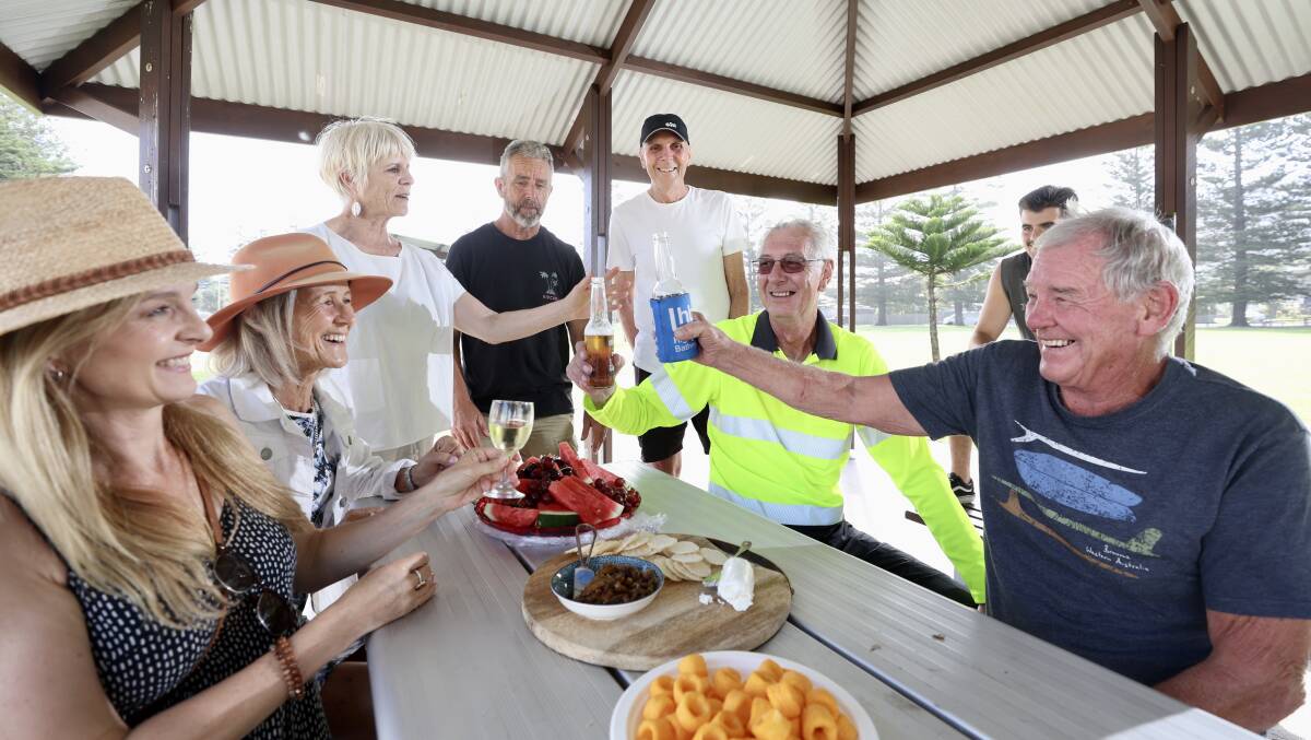 Thirroul residents toast their much-loved former postie Garry McCauley, in the high-visibility shirt. Picture by Adam McLean