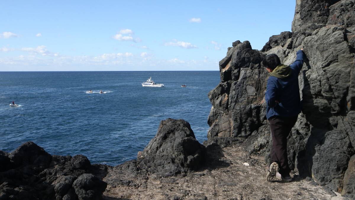 Dinh 'Michael' Bui's brother watches as emergency services search for the missing rock fisherman on May 3, 2023. Picture by Sylvia Liber