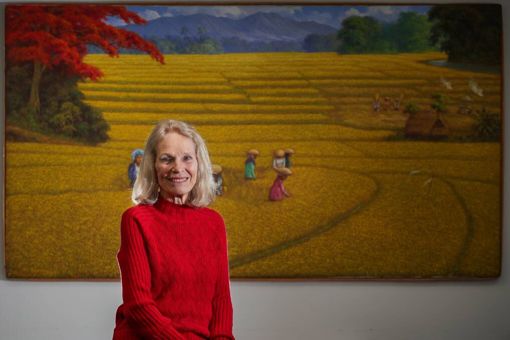 Linda Hogg in front of a painting she and husband John bought in Ubud after the attack. Picture by Adam McLean.