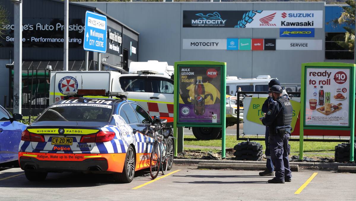 Police and paramedics near the scene of a crash involving a cyclist and a car in Fairy Meadow. Picture: Robert Peet
