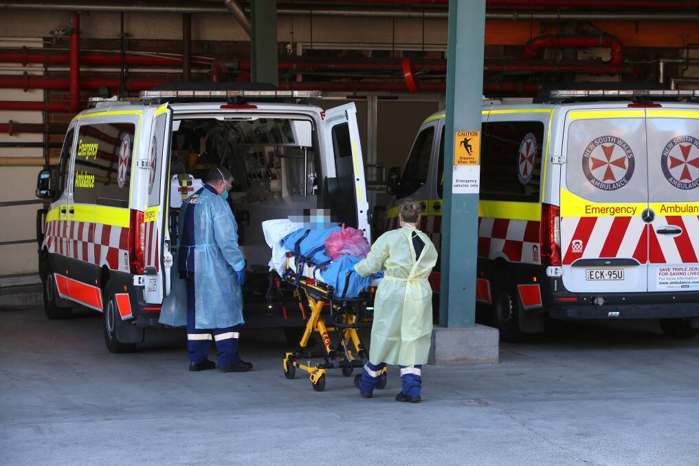 Paramedics with a patient at Wollongong Hospital earlier this year. Picture: Sylvia Liber