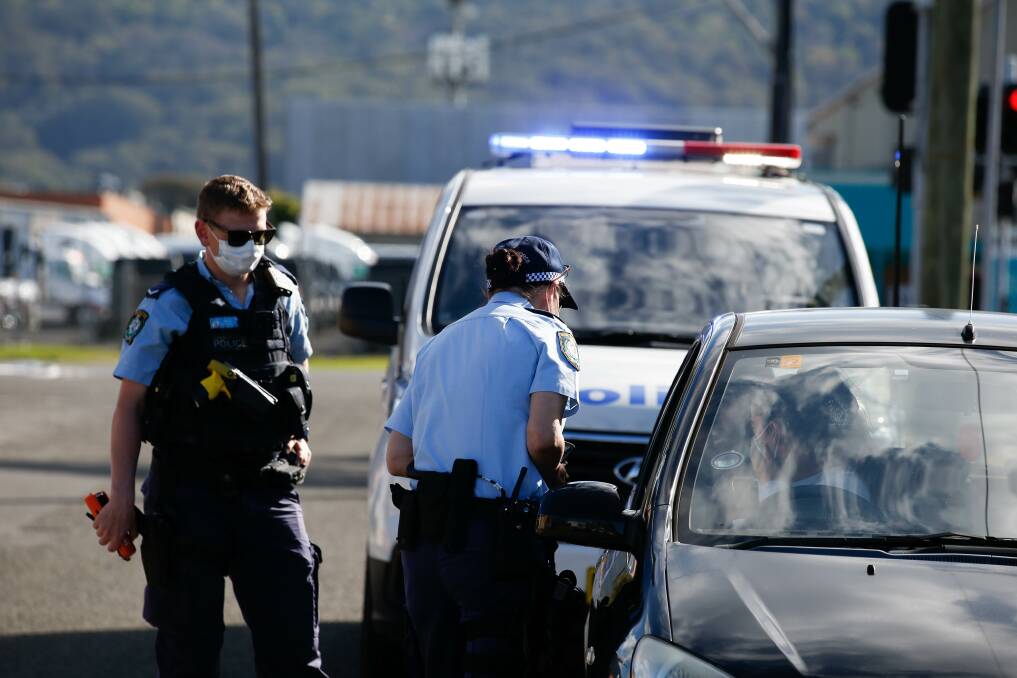 COMPLIANCE: Police check a vehicle in Towradgi during the most recent lockdown. Picture: Anna Warr